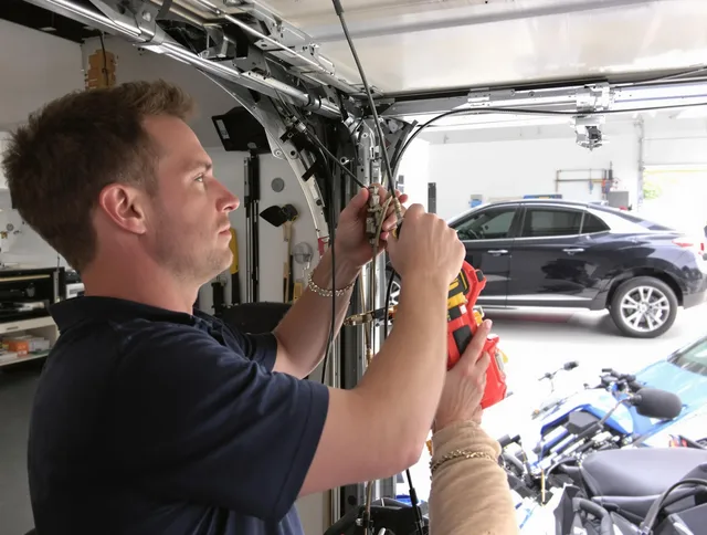 Warrensville Heights Garage Door Repair safety certified technician performing cable replacement in Warrensville Heights